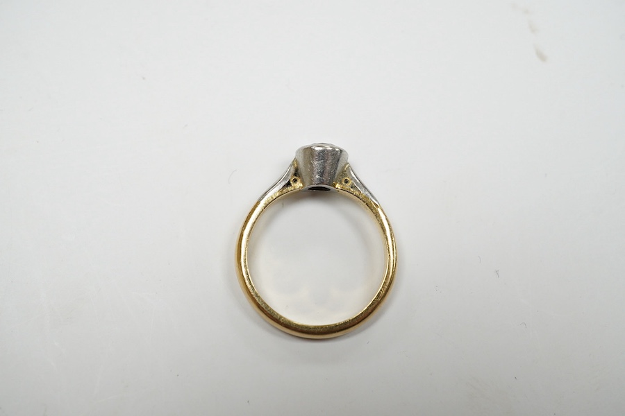 A yellow metal and collet set solitaire diamond set ring, size J/K, gross weight 4.2 grams. Condition - fair